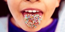 child with sprinkles on tongue