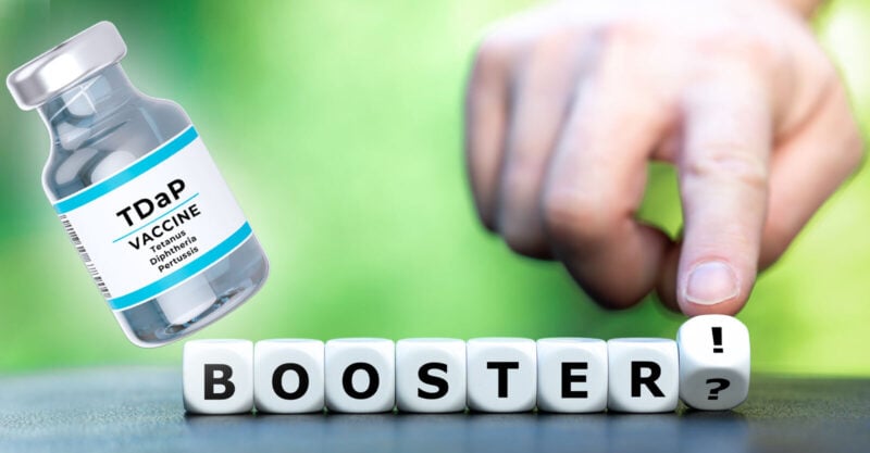 tdap vaccine bottle with booster block letters written on green background with a hand.