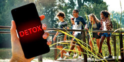 teens walking in nature and hand holding cellphone with word "DETOX" on top