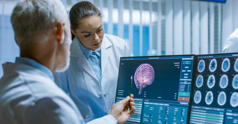 Two Medical Scientists in the Brain Research Laboratory Discussing Progress on the Neurophysiology Project Fighting Tumors.