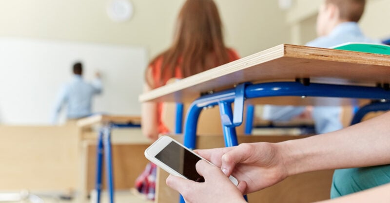 Licensed Save to Library Preview Crop Find Similar FILE #: 117532484 student boy with smartphone texting in school classroom.