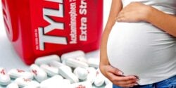 tylenol bottle and pills and pregnant woman