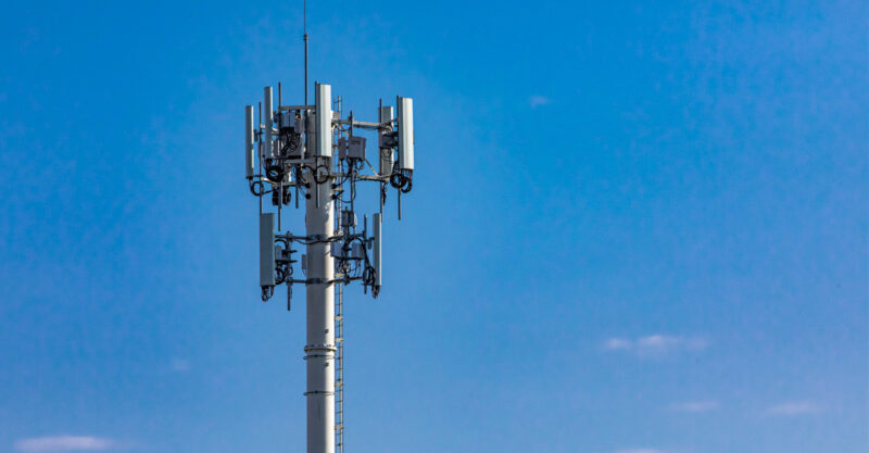 Photo of Cell Tower with Blue Sky in Background.