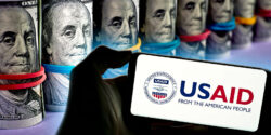 rolled money and USAID logo