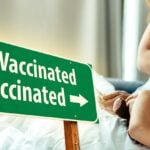 mom taking daughter's temperature and words "vaccinated" and "unvaccinated"