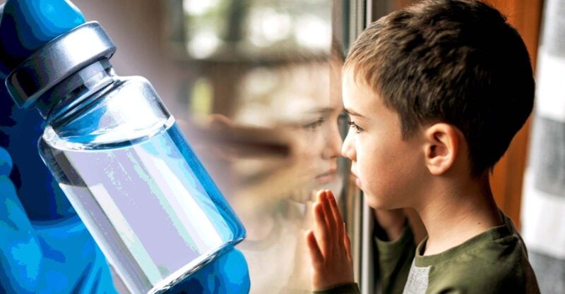 boy and vaccine bottle