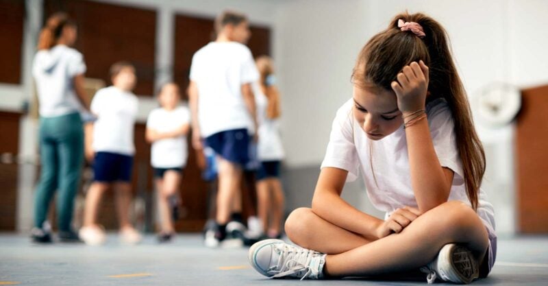 child sad and excluded from group