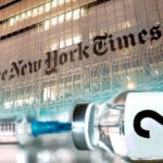 new york times building and vaccine bottle