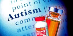 Autism definition with a tylenol bottle and vaccine bottle in front