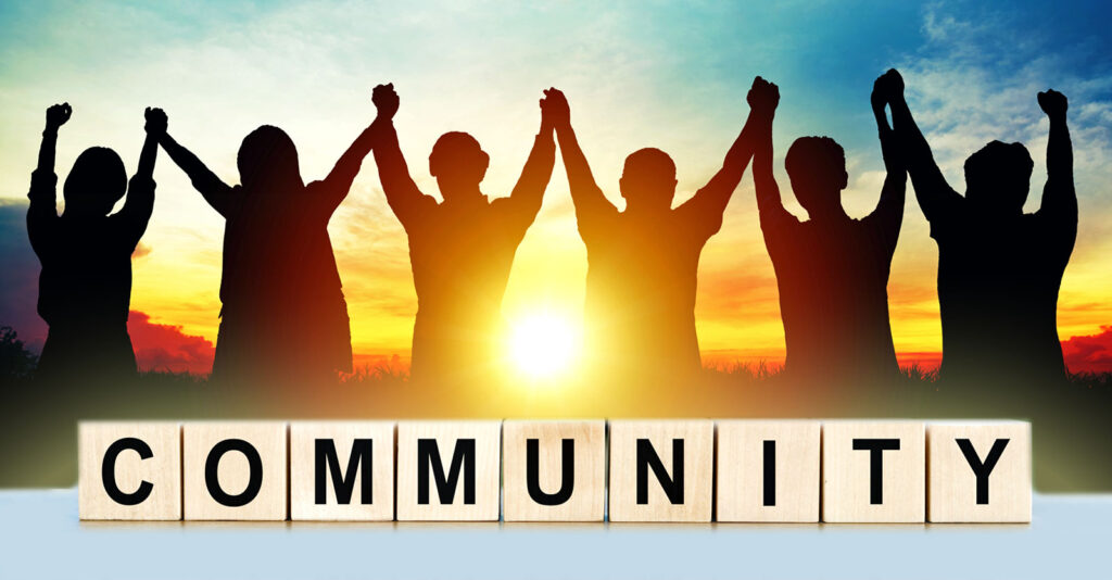 people joining hands and word "community"