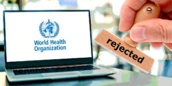 laptop with world health organization logo and hand holding stamp with word "rejected"