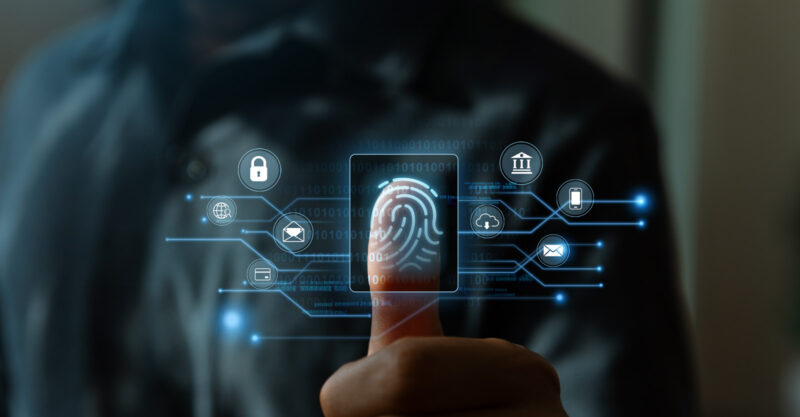 Fingerprint scanning and biometric authentication concept. Thumb pressing against fingerprint scanner.